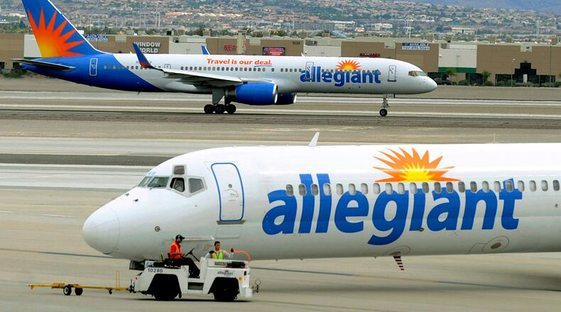 File - In this May 9, 2013, file photo, two Allegiant Air jets taxi at McCarran International Airport in Las Vegas. (AP Photo/David Becker, File)