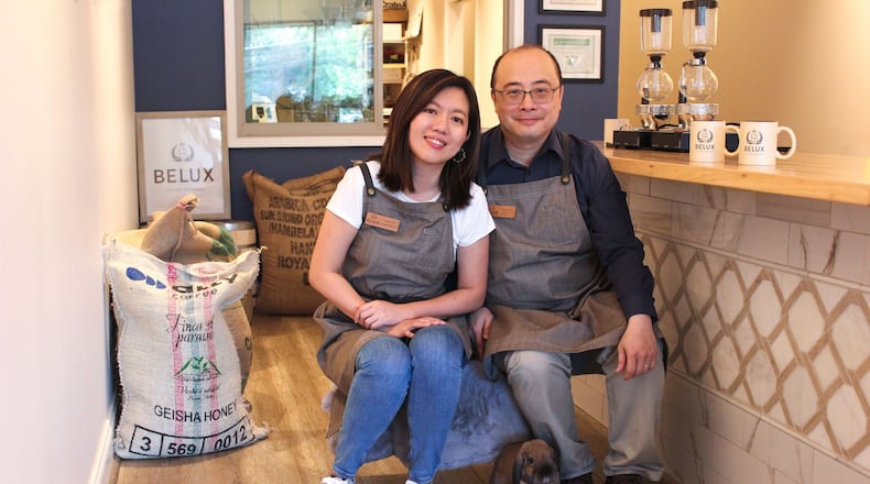 Bela, a Holland Lop rabbit, sits at the feet of Lucy Liu (left) and Ben Li of Belux Coffee Roasters. The pet bunny inspired the name of their company, and his image is on their logo. CONTRIBUTED BY DEBORA FANG