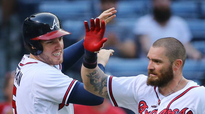 Jonny Gomes is greeted by Braves teammate Freddie Freeman after Gomes hit a two-run homer against the Rockies at Turner Field on Monday, Aug. 24, 2015, at Turner Field. (Curtis Compton/ccompton@ajc.com)