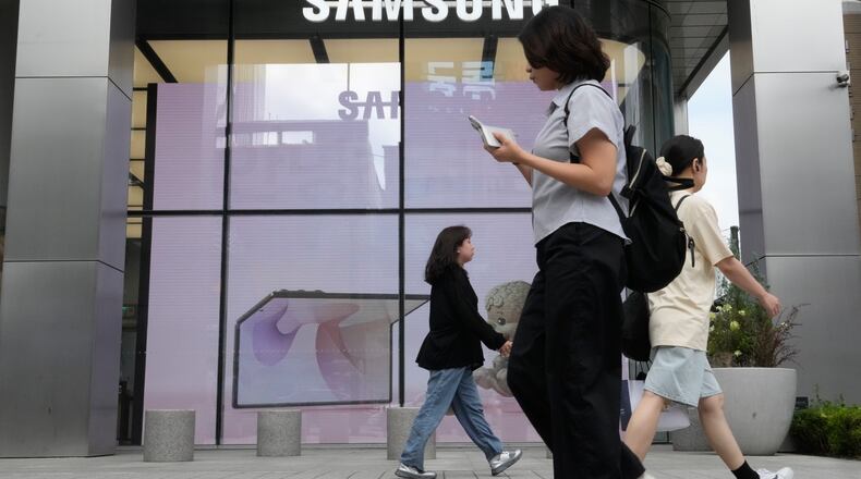 People pass by Samsung Gangnam store in Seoul, South Korea, Thursday, July 30, 2026. (AP Photo/Ahn Young-joon)