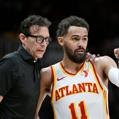Hawks head coach Quin Snyder (left) and guard Trae Young confer during an NBA basketball game at State Farm Arena on April 1 in Atlanta. Young and Snyder have built a strong relationship since the team hired Snyder in 2023. (Hyosub Shin/AJC)