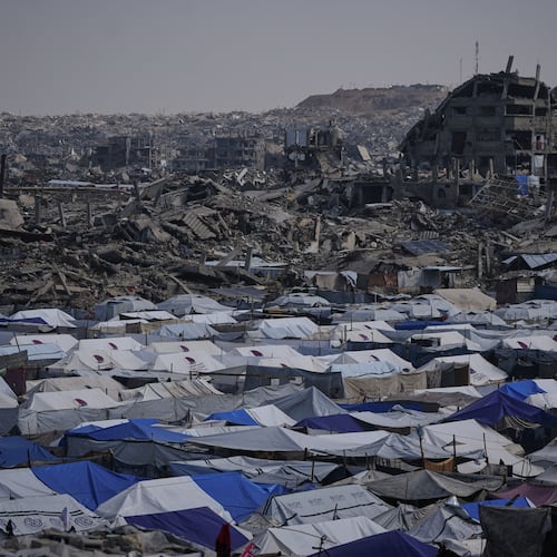 Tents sheltering displaced Palestinians stand amid the destruction left by the Israeli air and ground offensive in Gaza City Friday, Dec. 5, 2025. (AP Photo/Abdel Kareem Hana)