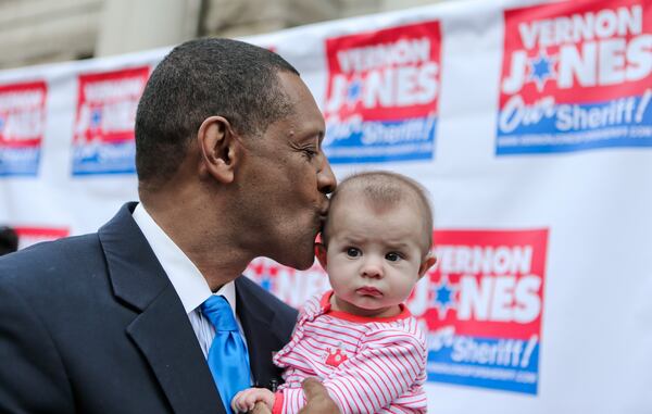 Vernon Jones kisses 5-month-old Harper Gonzales, daughter of Mario and Jacqueline Gonzales, during the event announcing his campaign for sheriff. Jones served two terms as DeKalb's CEO between 2001 and 2008. (John Spink/AJC file photo)