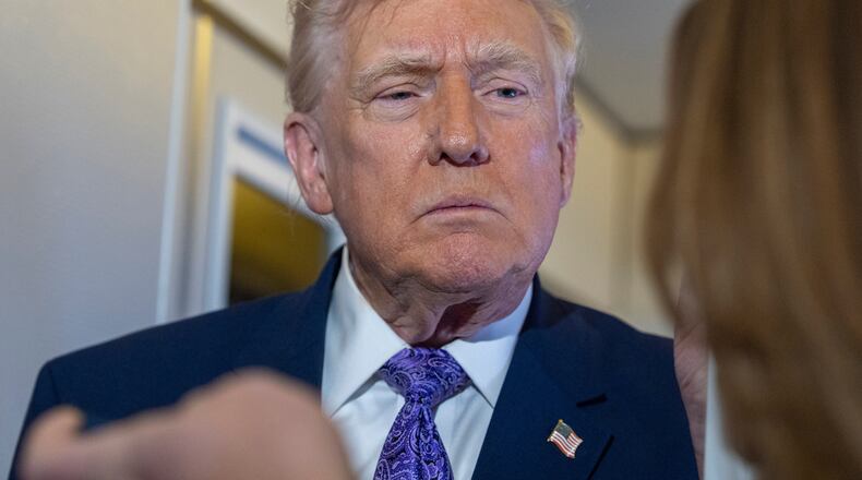 President Donald Trump speaks with reporters while in flight on Air Force One from his Mar-a-Lago estate in Palm Beach, Fla., to Joint Base Andrews, Sunday, Nov. 30, 2025. (AP Photo/Alex Brandon)