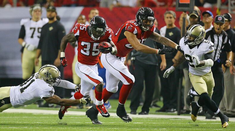 Falcons running back Antone Smith breaks away from Saints safety Jairus Byrd picking up a block from Levine Toilolo for a 54-yard touchdown during the third quarter in their NFL football game on Sunday, Sept. 7, 2014, in Atlanta.