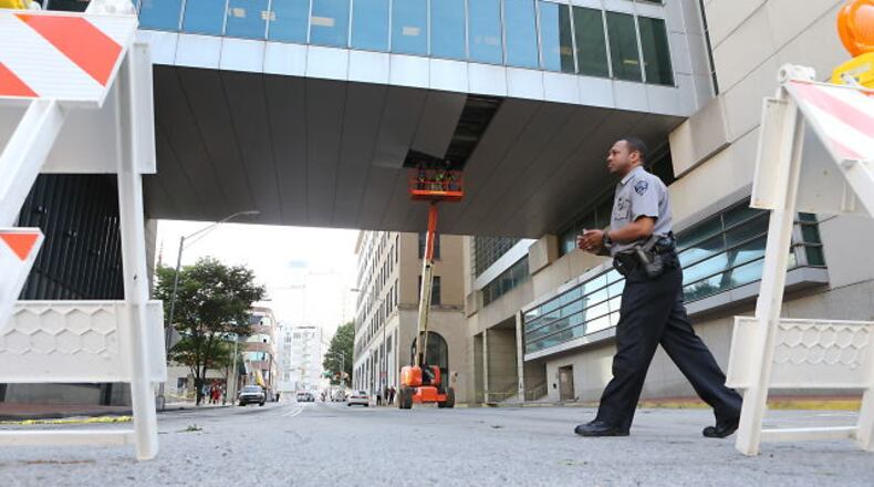 In downtown Atlanta, Forsyth Street was closed from Martin Luther King Jr. Drive to Alabama Street Friday morning while crews worked to repair storm damage at the Nunn Federal Building, according to Atlanta police spokeswoman Kim Jones. The storm apparently loosened architectural panels on the underside of a pedestrian bridge across Forsyth Street.