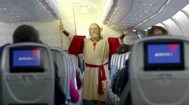 'Moses' parts the passengers to keep the aisle clear in Delta's latest pre-flight safety briefing.
