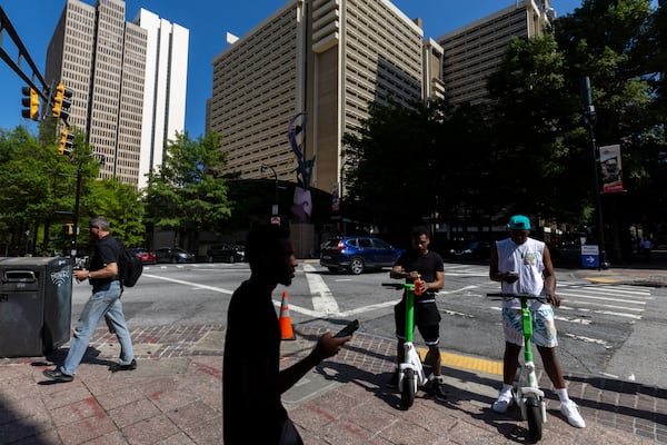 Pedestrians walk by the intersection of Peachtree and Baker streets in Atlanta on Tuesday, May 20, 2025. A man was fatally struck in a hit-and-run at the intersection on Sunday. (Arvin Temkar/AJC)