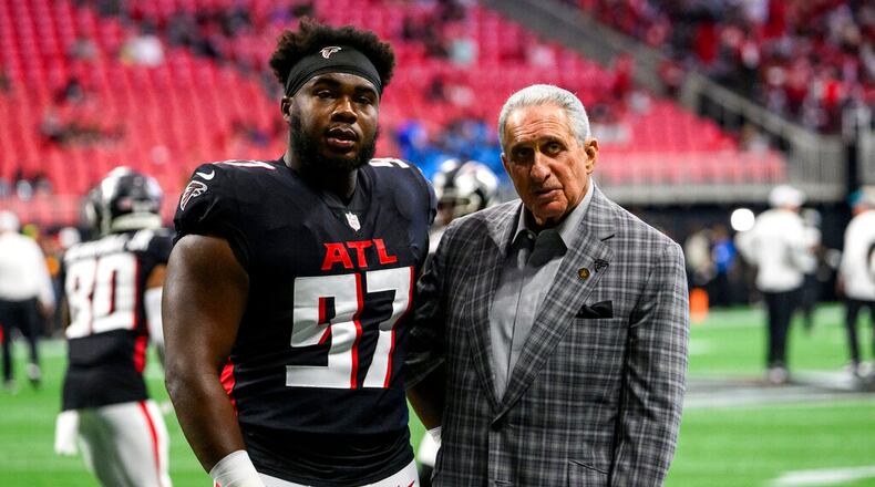 Atlanta Falcons defensive end Grady Jarrett (97) and owner Arthur Blank look to the stands before an NFL football game against the Jacksonville Jaguars, Saturday, Aug. 27, 2022, in Atlanta. The Atlanta Falcons won 28-12. (AP Photo/Danny Karnik)