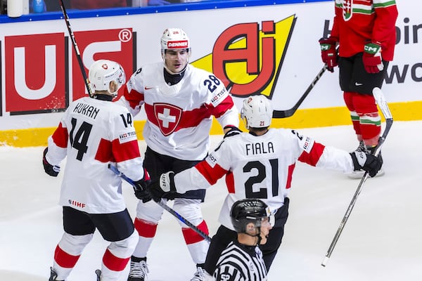 Switzerland's forward Timo Meier, center, celebrates his goal with his teammates Dean Kukan, left and Kevin Fiala, center right after scoring, during the IIHF 2025 World Championship preliminary round group B game between Hungary and Switzerland, at the Jyske Bank Boxen, in Herning, Denmark, Sunday, May 18, 2025. (Salvatore Di Nolfi/Keystone via AP)