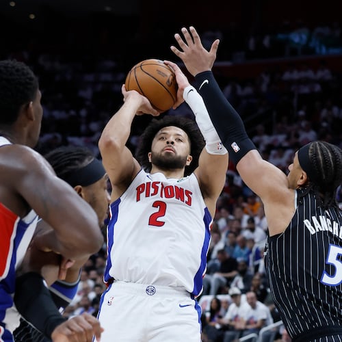 Detroit Pistons guard Cade Cunningham (2) takes a shot against Orlando Magic forward Paolo Banchero (5) as Pistons center Jalen Duren (0) helps defend during the first half in Game 2 of a first-round NBA basketball playoffs series Wednesday, April 22, 2026, in Detroit. (AP Photo/Duane Burleson)