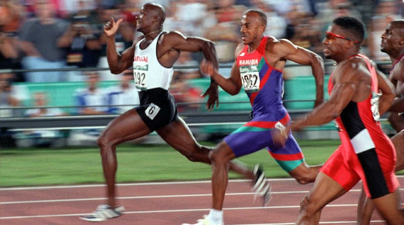 Donovan Bailey of Canada - followed by Frankie Fredericks of Namibia and Ato Boldon of Trinidad - leads the pack in the record-setting men's 100-meter run Saturday, July 27, 1996, at Olympic Stadium in Atlanta. (Rich Addicks/AJC)