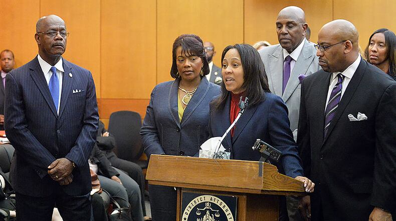 Outgoing Fulton County District Attorney Paul Howard, left, and the onetime colleague who bested him in the August runoff, Fani Willis, at the lectern, during sentencing for a past case. AJC file photo: Kent D. Johnson