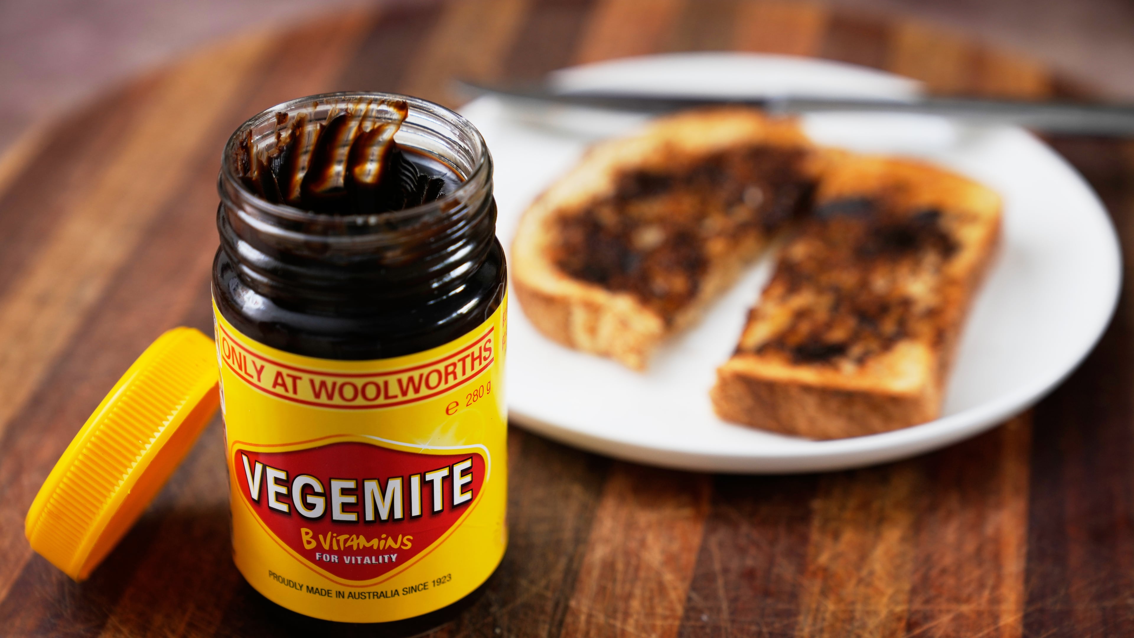 A piece of toast is prepared with Vegemite in Sydney, Australia, Monday, Nov. 17, 2025. (AP Photo/Rick Rycroft)