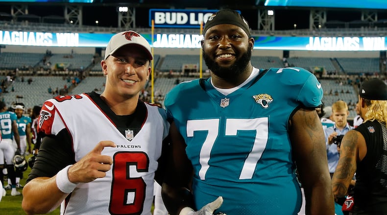 Falcons quarterback Kurt Benkert and Jacksonville’s Brandon Smith, both rookies, pose following a preseason game Aug. 25, 2018, at TIAA Bank Field in Jacksonville, Fla.