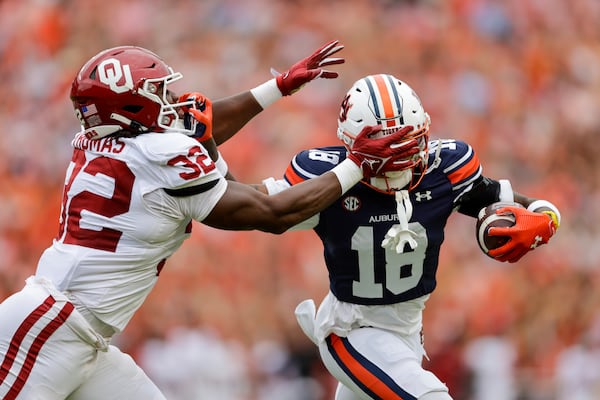 FILE - Auburn's Sam Jackson V (18) is tackled by Oklahoma's R Mason Thomas (32) during the first half of an NCAA football game on Saturday, Sept. 28, 2024 in Auburn, Ala. (AP Photo/Stew Milne, File)