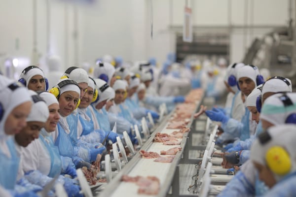FILE - Workers prep poultry at the meatpacking company JBS, in Lapa, in the Brazilian state of Parana, March 21, 2017. (AP Photo/Eraldo Peres, File)