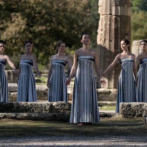 Actor Mary Mina playing the role of high priestess, center, performs during a rehearsal ahead of the flame lighting for the Milan Cortina 2026 Winter Olympics, at the Ancient Olympia site, Greece, Monday, Nov. 24, 2025. (AP Photo/Thanassis Stavrakis)