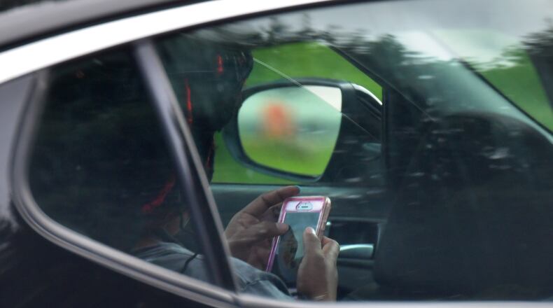 The Hands-Free Georgia Act prohibits motorists from handling their phones while driving. HYOSUB SHIN / HSHIN@AJC.COM