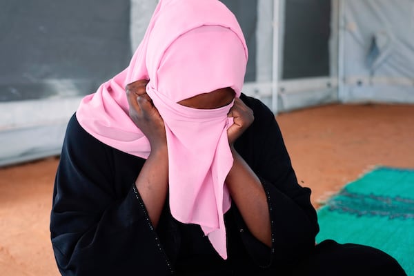FILE - A woman who fled war in Sudan and requested anonymity because she feared retribution after reporting sexual exploitation, sits in a refugee camp in Adre, Chad, Oct. 3, 2024. (AP Photo/Sam Mednick, File)