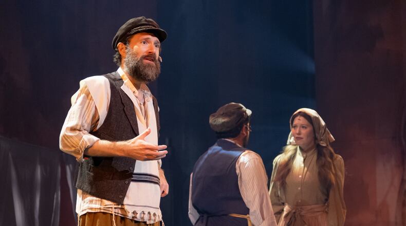 From left, the poor dairyman Tevye (Jacob Fishel) struggles with a changing world, as Motel (Brian Wittenberg) and Tevye's daughter Tzeitel (Carly Ann Lovell) fall in love in "Fiddler on the Roof." Photo: Mason Wood