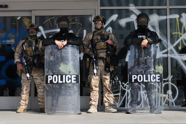 US Customs and Border Protection officers guard an entrance of the Federal Building in Los Angeles while protesters rally during a demonstration in response to a series of US Immigration and Customs Enforcement (ICE) raids throughout the country, on Tuesday, June 10th, 2025. (Gabrielle Lurie/San Francisco Chronicle via AP)