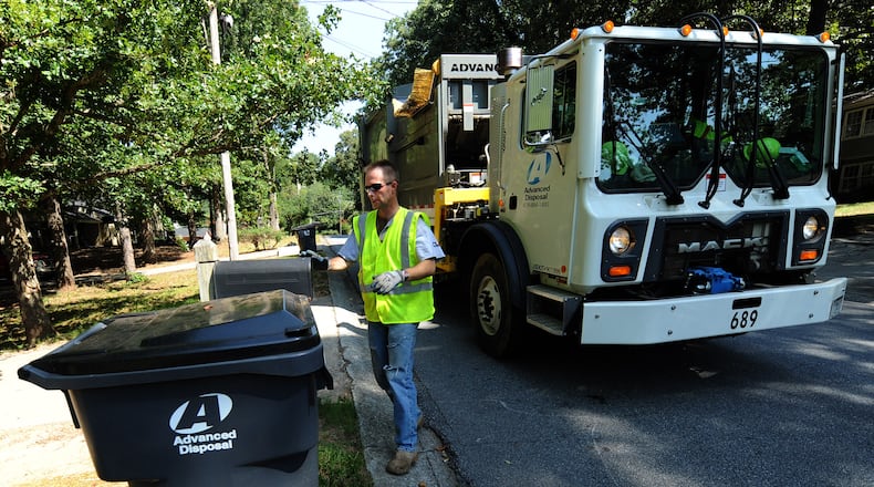 In this 2010 AJC file photo, John Curler walks toward a garbage container on Brookview Trail in Lawrenceville.
