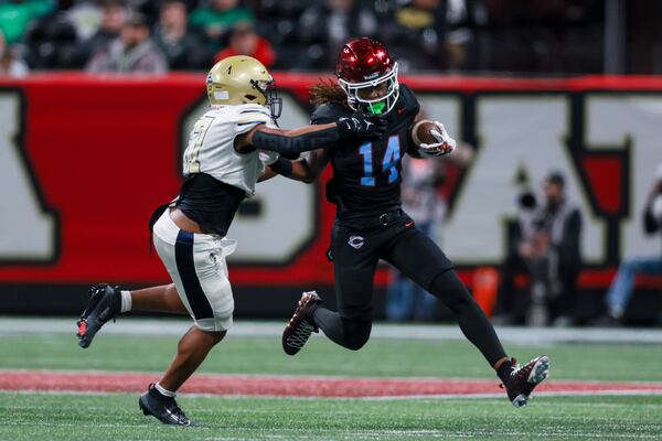 Zach Watts (right) returns a punt for Carver of Columbus against Hapeville Charter in the Class 2A championship game at Mercedes-Benz Stadium in December. Watts transferred to Carrollton in the offseason. (Jason Getz/AJC 2025)
