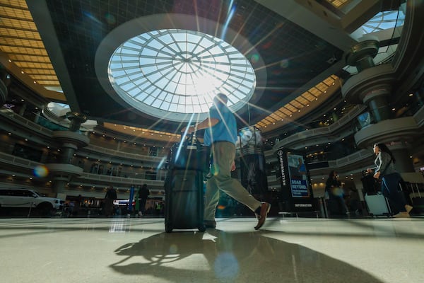 “We are 50 years out with our planning," Atlanta Mayor Andre Dickens told the AJC. A traveler walks through the atrium at Hartsfield-Jackson Atlanta International Airport on Thursday, Nov. 6, 2025. (Miguel Martinez/ AJC)