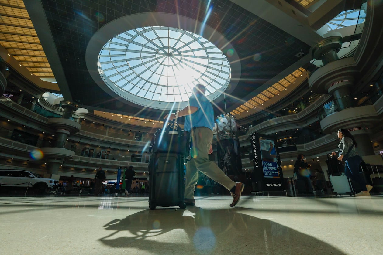 A traveler walks through the atrium at Hartsfield-Jackson Atlanta International Airport Thursday, Nov. 6, 2025. Atlanta is among the airports where the FAA has reduced flights due to the government shutdown and a shortage of air traffic controllers. (Miguel Martinez/AJC)