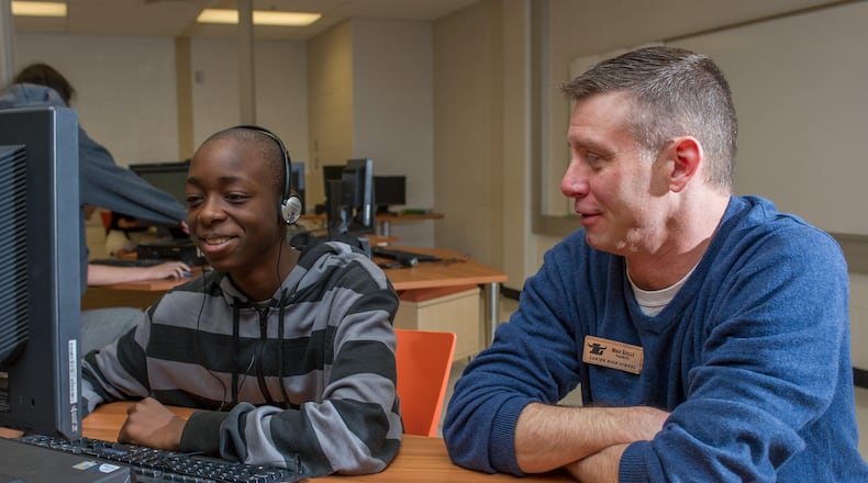 Mike Riley (right), a technology teacher at Lanier High in Sugar Hill, piloted the EarSketch program that teaches students to compose original music through coding. Contributed.