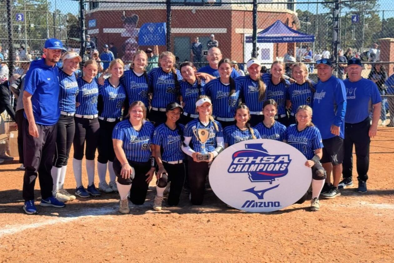 Bremen coaches and players celebrate with the trophy after winning the Class A Division I fast-pitch softball championship on Nov. 1, 2025, in Columbus. (Courtesy of Georgia High School Association)