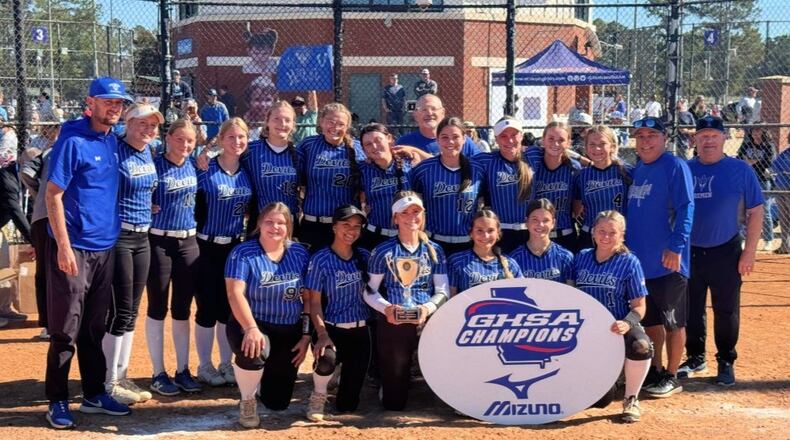 Bremen coaches and players celebrate with the trophy after winning the Class A Division I fast-pitch softball championship on Nov. 1, 2025, in Columbus. (Courtesy of Georgia High School Association)