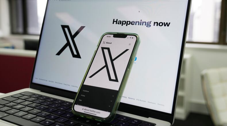 FILE - The opening page of X is displayed on a computer and phone, Oct. 16, 2023, in Sydney. (AP Photo/Rick Rycroft, File)