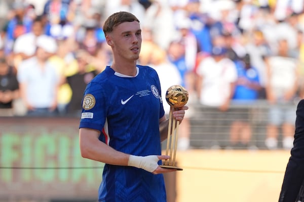 Chelsea's Cole Palmer (10) holds the golden ball trophy following the Club World Cup final soccer match between Chelsea and PSG in East Rutherford, N.J., Sunday, July 13, 2025. (AP Photo/Seth Wenig)