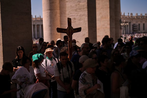 Pilgrims arrive to visit St. Peter's Basilica on the seventh of nine days of mourning for late Pope Francis, at the Vatican, Friday, May 2, 2025. (AP Photo/Francisco Seco)