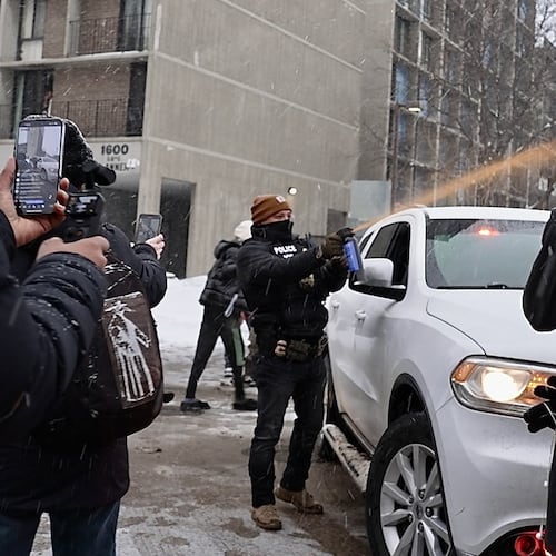 Activists confronted a group of Immigration and Customs Enforcement officers in the largely Somali neighborhood of Cedar-Riverside in Minneapolis, Tuesday, Dec. 9, 2025. (AP Photo/Mark Vancleave)