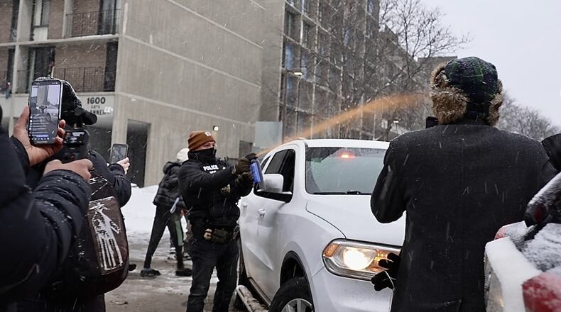 Activists confronted a group of Immigration and Customs Enforcement officers in the largely Somali neighborhood of Cedar-Riverside in Minneapolis, Tuesday, Dec. 9, 2025. (AP Photo/Mark Vancleave)