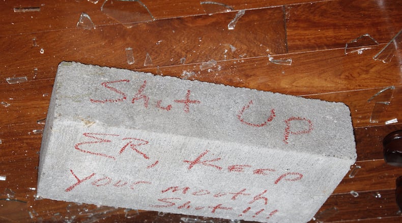 Crime scene photos from the Atlanta Police Department show a brick that landed in Elvin “E.R.” Mitchell’s home in southwest Atlanta in September 2015. Mitchell is a key figure in a federal criminal probe of city of Atlanta contracting.