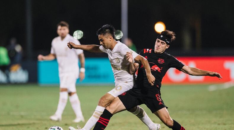Atlanta United’s Pity Martinez fights for control during Saturday night’s game against the New York Red Bulls.