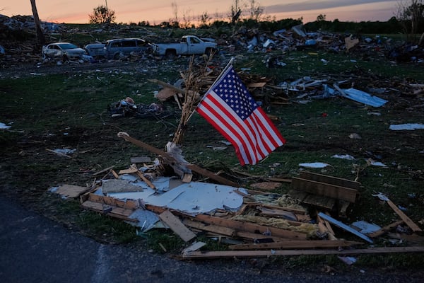 FILE - An American flag is posted near destroyed homes after a tornado passed through the area on May 17, 2025, in London, Ky. (AP Photo/Carolyn Kaster, File)