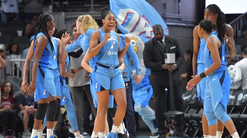 Atlanta Dream forward Monique Billings (center) and teammates celebrate their victory over the Indiana Fever Wednesday in WNBA action at State Farm Arena. (Hyosub Shin/hshin@ajc.com)