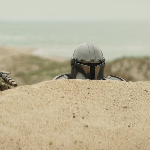 This image released by Disney shows The Mandalorian, portrayed by Pedro Pascal, right, and Grogu in a scene from Lucasfilm's "Star Wars: The Mandalorian and Grogu." (Lucasfilm Ltd. - Disney via AP)