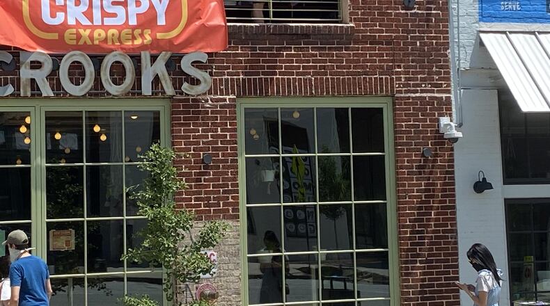 Greg Best of How Crispy Express uses a plastic bucket to lower an order to a customer. CONTRIBUTED BY HALFWAY CROOKS