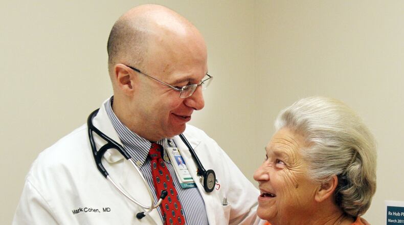 November 2011: Dr. Mark Cohen gets a hug from patient Wanda Massengale, from Adairsville, at the Piedmont Heart Institute. Says Cohen: “I grew up in the 1960s and I watched ‘Marcus Welby, M.D.,’ and that’s who I wanted to be. I wanted to be THE doctor.”