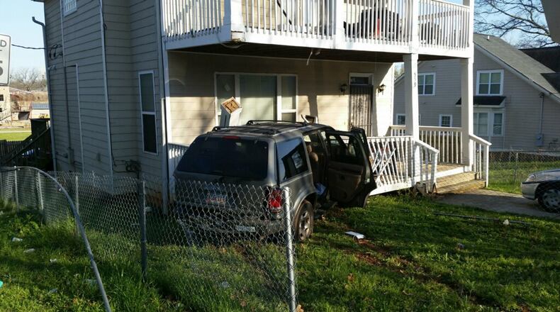 A Ford Explorer hit a house on North Avenue after the driver was shot twice in the back. (Credit: Atlanta Police Department)