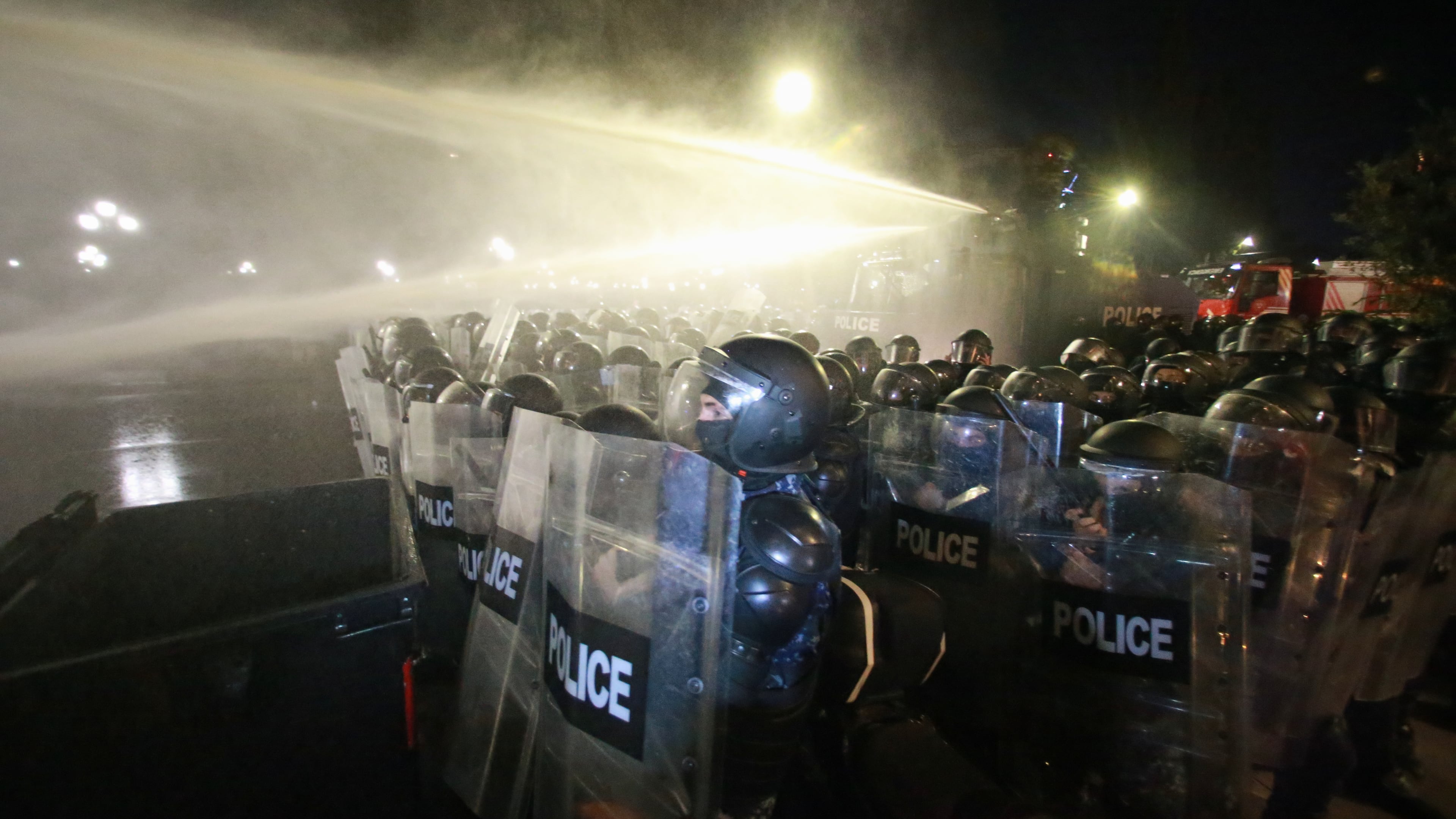 Police use a water cannon to block protesters during an opposition rally in the city center of Tbilisi, Georgia, on Saturday, Oct. 4, 2025, boycotting the municipal elections and call for the release of political opponents. (AP Photo/Zurab Tsertsvadze)