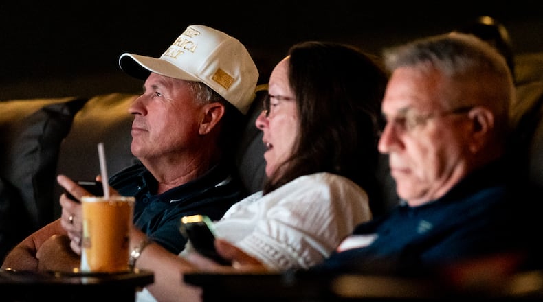 Attendees watch the Republican National Convention on Thursday from the Springs Cinema & Taphouse in Sandy Springs. The event was sponsored by the Republican parties in Cobb, DeKalb, Fulton and Gwinnett counties. (Seeger Gray / AJC)