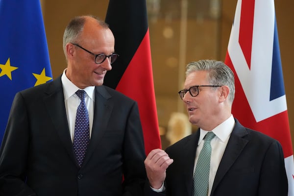 Britain's Prime Minister Keir Starmer, right, and German Chancellor Friedrich Merz, left, talk as they attend a signing ceremony of a wide-ranging bilateral cooperation treaty in London, Thursday, July 17, 2025.(AP Photo/Frank Augstein, Pool)
