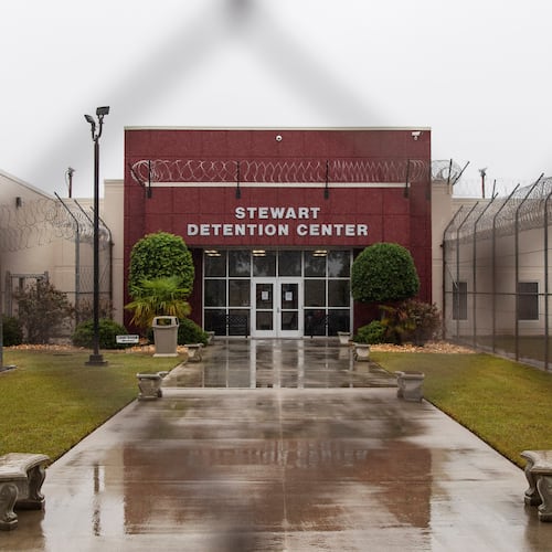 The Stewart Detention Center in Lumpkin, is seen through the front gate in this 2019 file photo. As of January, the facility held more than 2,000 detainees, according to ICE detention data. (David Goldman/AP)